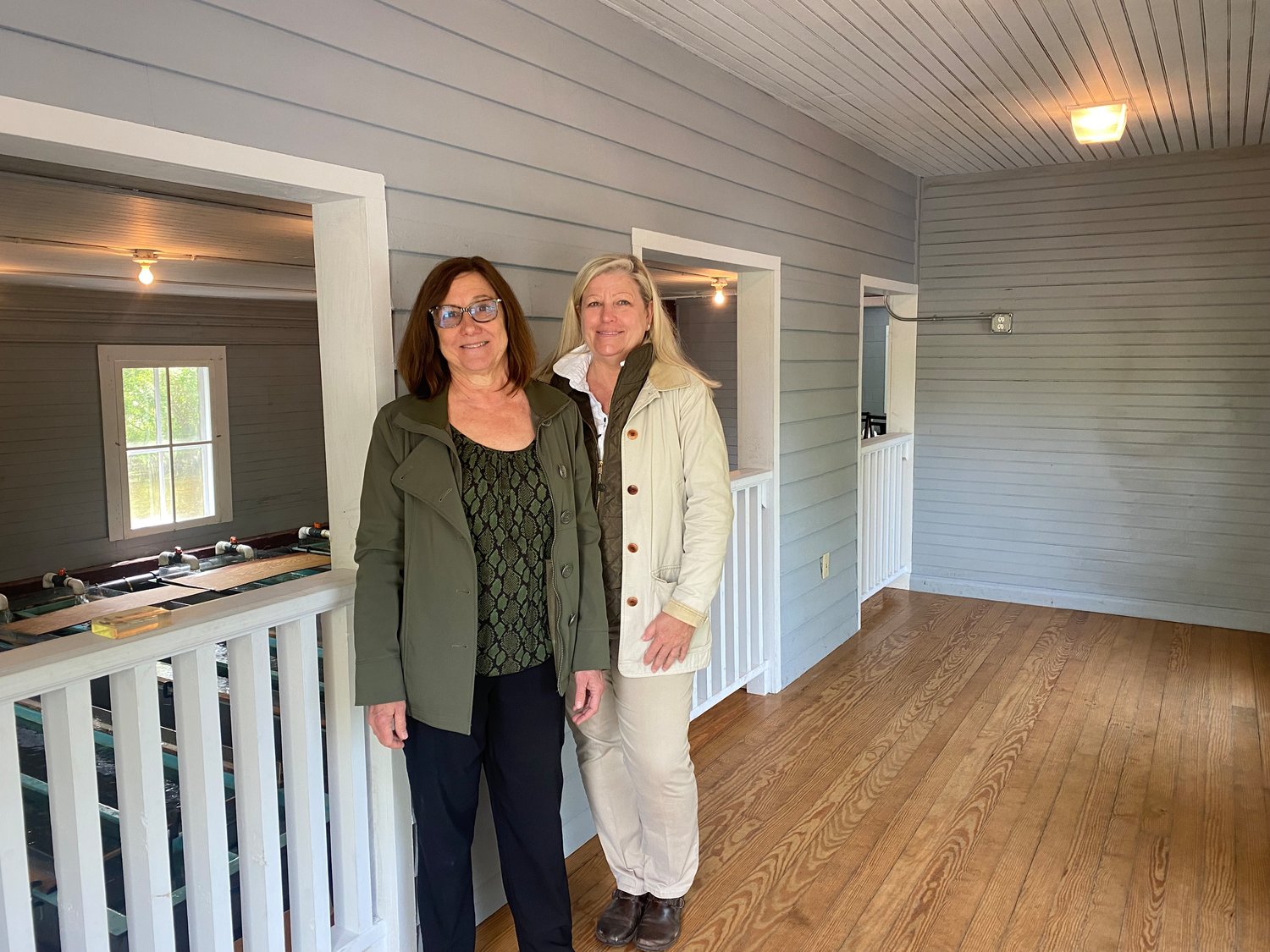 President of the Friends of Connetquot Janet Marie Soley and park manager Susanne Wuehler stand in the observation deck of the historic hatchery building that will be turned into an environmental interpretive center.